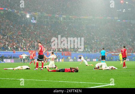 Michael Gregoritsch, AUT 11 Kevin Danso, AUT 4 , sad after final whistle ,  Salih Oezcan, Tuerkiye 15 celebrate in the best of 16 match AUSTRIA  - TueRKIJE 1-2 of the UEFA European Championships 2024  on Jul 02, 2024  in Leipzig, Germany.  Photographer: ddp images / star-images Stock Photo