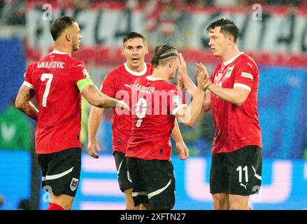 Michael Gregoritsch, AUT 11 celebrates his goal, happy, laugh, celebration, 1-2 with Marcel Sabitzer, AUT 9 Marko ARNAUTOVIC, AUT 7  in the best of 16 match AUSTRIA  - TueRKIJE 1-2 of the UEFA European Championships 2024  on Jul 02, 2024  in Leipzig, Germany.  Photographer: ddp images / star-images Stock Photo