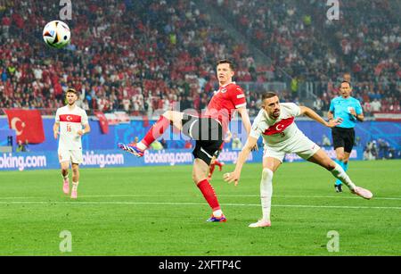 Michael Gregoritsch, AUT 11  compete for the ball, tackling, duel, header, zweikampf, action, fight against Merih Demiral, Tuerkiye 3  in the best of 16 match AUSTRIA  - TueRKIJE 1-2 of the UEFA European Championships 2024  on Jul 02, 2024  in Leipzig, Germany.  Photographer: ddp images / star-images Stock Photo