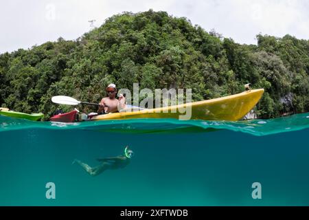 Woman snorkeling and man in kayak Stock Photo