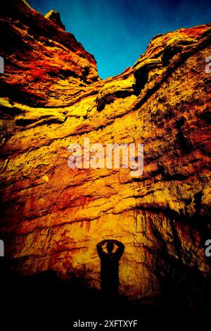 Shadow of a man cast on a large rock in Nevada. Stock Photo
