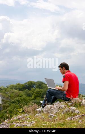 Young man using laptop computer, Murguia, Alava, Euskadi, Spain Stock Photo