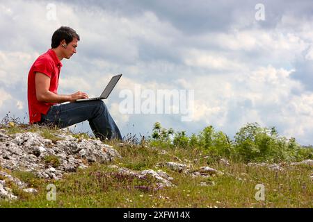 Young man using laptop computer, Murguia, Alava, Euskadi, Spain Stock Photo