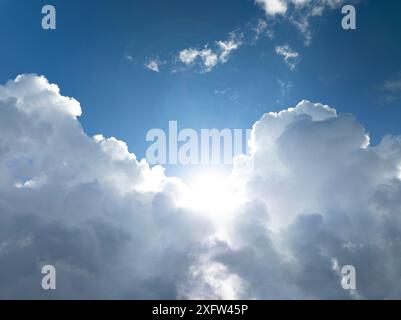 The sun shining through the puffy clouds Stock Photo