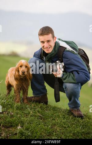 Man in the mountains with dog and camera, Gipuzkoa, Basque Country, Spain Stock Photo