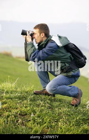 25 30 year old mountain climber taking pictures with digital SLR camera. Guipúzcoa, Euskadi, Spain Stock Photo