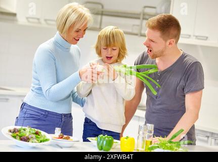 Family in the kitchen. Three generations. Healthy eating. Healthy growth. Stock Photo