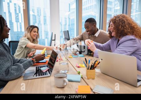 Cheerful diverse team discussing ideas in office Stock Photo