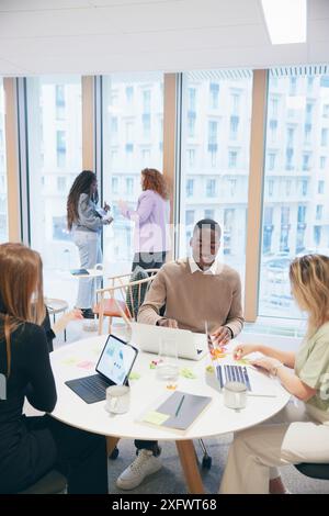 Multiracial group of corporate employees discussing strategies in office Stock Photo