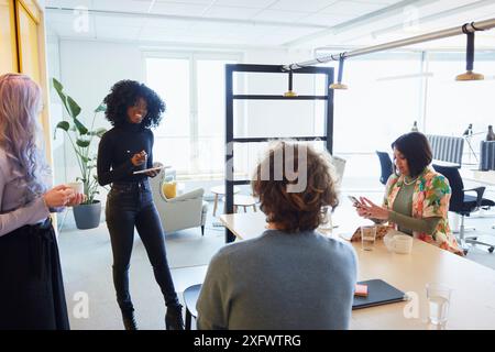 Multiracial corporate colleagues discussing over table in office Stock Photo
