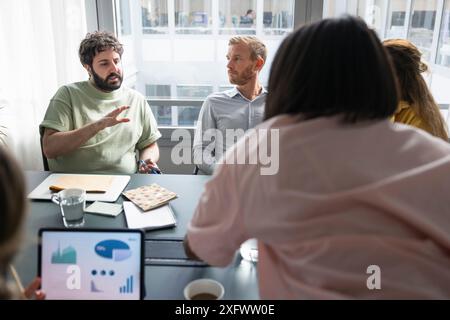 Businessman discussing new ideas with colleagues in office Stock Photo