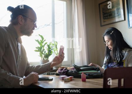 Father confronting daughter about vape pens Stock Photo