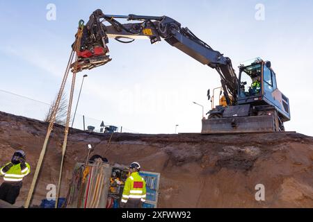 Maintenance engineer using construction vehicle at site Stock Photo