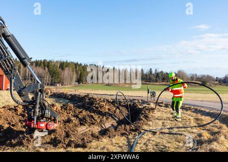 Maintenance engineer installing fiber optic cable at construction site Stock Photo