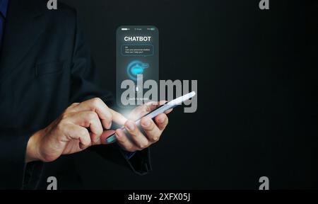 Chat with Ai. A man using chatbot application technology to communicate with artificial intelligence via his smartphone Stock Photo
