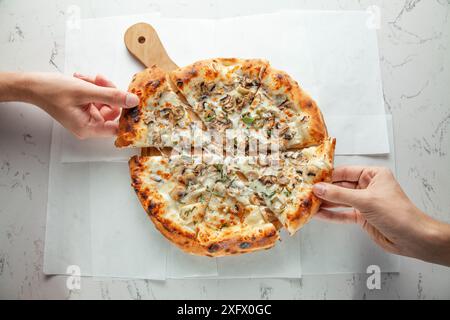Italian authentic naples pizza four cheese and all vegetable and mushrooms, eating at a restaurant. Stock Photo