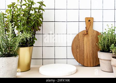 Stylish white kitchen background with marble white round podium for advertising eco or healthy products, food, objects for kitchen. Cutting board and Stock Photo
