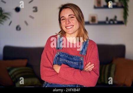 Portrait of a young caucasian blonde woman looking at camera with toothy smile. Stock Photo