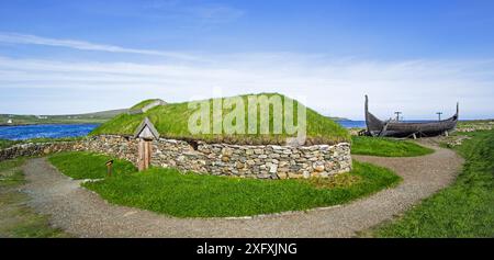 Reconstruction of Norse Viking longhouse and the Skidbladner, a full size replica of Gokstad ship at Brookpoint, Unst, Shetland Islands, Scotland, UK, May 2018 Stock Photo