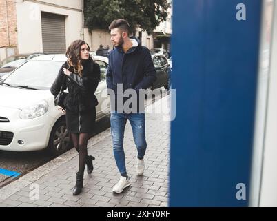 Young couple walking in a winter day. Urban fashion and relationship concept. Stock Photo