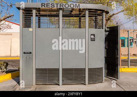 Outdoor, stand-alone public restroom stall in public area. Stock Photo