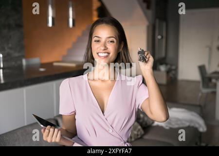Happy young homeowner holding keys from new apartment Stock Photo - Alamy
