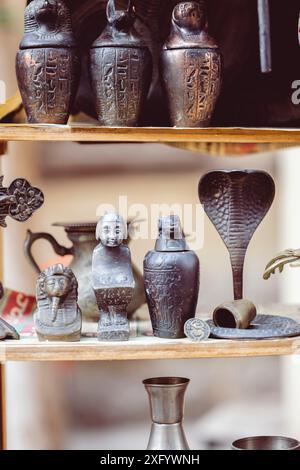 A collection of small figurines on a wooden shelf in an Egyptian souvenir shop Stock Photo