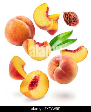 Red peaches, juicy peach slices, leaves and peach stone levitating in air on white background. File contains clipping paths. Stock Photo