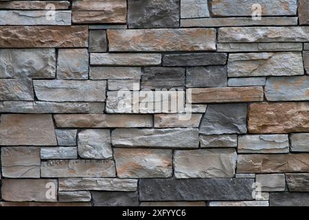 Brown and grey brick stone wall full frame background Stock Photo