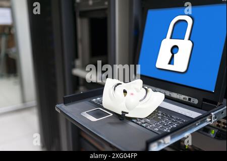 Masked Hacker in Computer Server room Concept .Editorial photo Stock Photo
