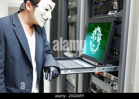 Masked Hacker in Computer Server room Concept .Editorial photo Stock Photo