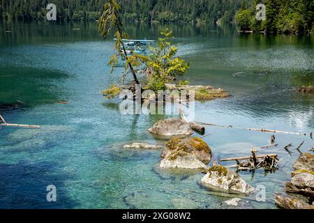 WA25475-00...WASHNGTON - Float plane parked in a small cove along the shore of Baker Lake. Stock Photo