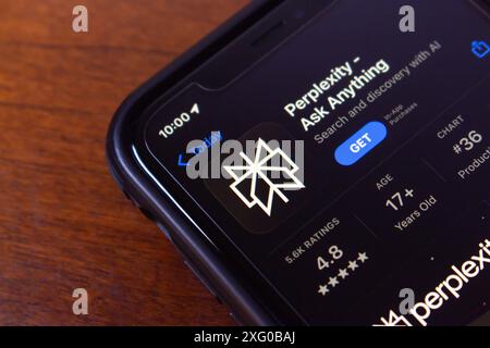 Perplexity.ai app seen in an App Store on an iPhone. Perplexity AI is a research and conversational search engine powered by AI chatbots. Stock Photo
