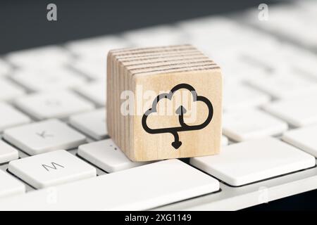 Cloud computing icon on wooden block on computer keyboard Stock Photo