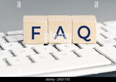 FAQ word on wooden block on computer keyboard. Frequently asked question concept Stock Photo