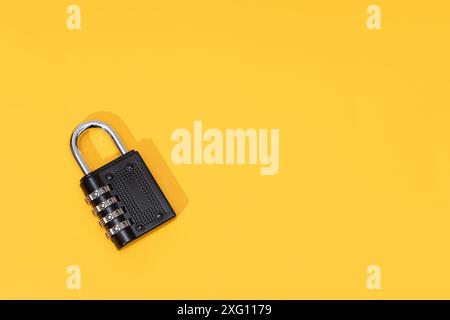 Number Padlock isolated on yellow background. Copy space. Top view Stock Photo