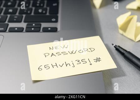 Change of password to a stronger one- Message on sticky note on laptop. Computer security management concept Stock Photo