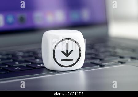 Download Data Storage Concept. Download icon on cube block on laptop Stock Photo