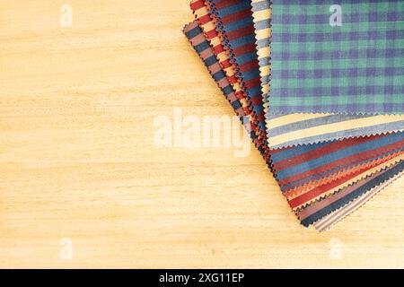 Fabric textile catalog on wooden table. Fabric samples upholstery and decoration. Copy space Stock Photo