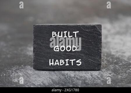 The words build good habits are standing on a blackboard, change lifestyle, healthy and positive attidude, motivation concept Stock Photo