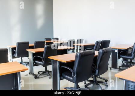 Empty classroom with table and chairs for lecture or seminar in university. Stock Photo