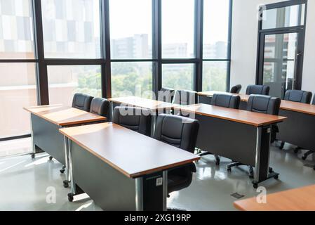 Empty classroom with table and chairs for lecture or seminar in university. Stock Photo