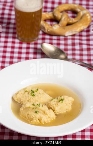 Bavarian dumpling soup on a tablecloth Stock Photo