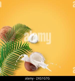 coconuts with milk splash and leaf on a yellow background. Stock Photo