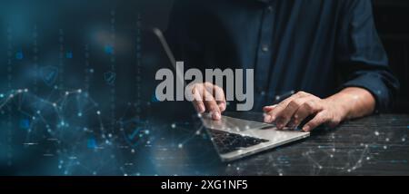 Cybersecurity concept with hands typing on a laptop keyboard, featuring digital security icons overlay. network security, and the role of technology i Stock Photo