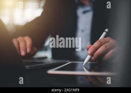 businessman using stylus pen working on a digital tablet Stock Photo