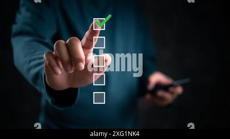 Hand touching checklist, green check mark highlighted. Concept of task completion, decision making, digital interface. Useful for business processes, Stock Photo