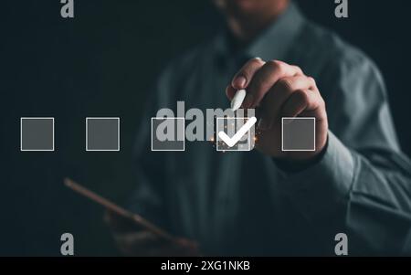 Hand of businessman marking checkbox on a digital interface. Depicts decision-making and task management. Ideal for business planning, evaluation, and Stock Photo