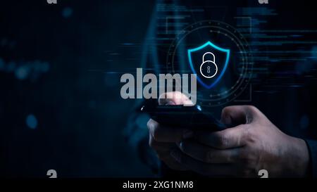 Hand holding smartphone with digital shield lock symbol, representing data protection and cybersecurity. Modern, dark background security and privacy. Stock Photo