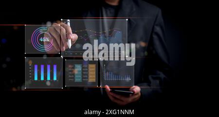 Businessman using a futuristic interface with various data charts and graphs, highlighting business analytics. Represents data-driven decision-making Stock Photo